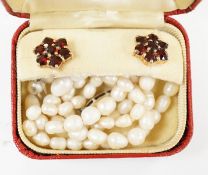 A pair of 9ct gold and garnet cluster set earrings and a freshwater? pearl necklace with a silver
