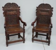 A pair of 17th century style inlaid panelled oak wainscot chairs, width 57cm, depth 40cm, height