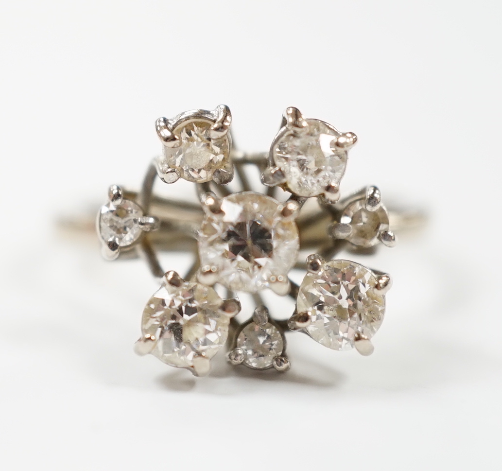 A modern 18ct white gold and graduated eight stone diamond cluster set dress ring, size S, gross