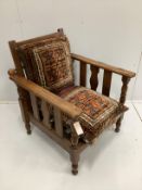 An early 20th oak reclining armchair with geometric saddlebag cushion seat and back width 70cm,