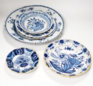 Five 18th century assorted Delft dishes and a plate, largest 35cm diameter