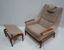 In the manner of Kofod Larsen, a mid century upholstered teak reclining armchair and adjustable foot