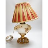 A Victorian porcelain oil lamp, probably Moore brothers, decorated with hops and gilt base,