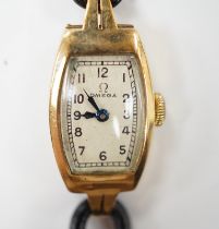 A lady’s 9ct gold Omega manual wind wrist watch, on a twin fabric strap.