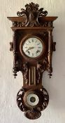 A late 19th century French carved walnut wall clock combined thermometer and barometer, dial and