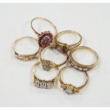 Seven assorted mainly modern 9ct gold and gem set dress rings, including three stone diamond and