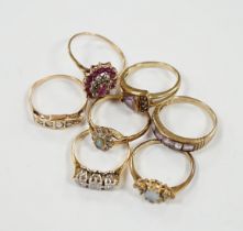 Seven assorted mainly modern 9ct gold and gem set dress rings, including three stone diamond and