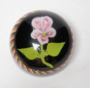 A glass ‘Flower’ paperweight, black ground, possibly Belgian, 8.5cm diameter