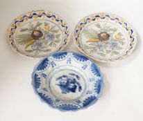 A Delft blue and white dish, c.1700 and two 18th century Delft polychrome dishes, 22cm (3)
