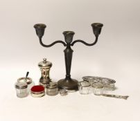 A group of mixed silver including a modern candelabrum, toilet jars and a pepper grinder.