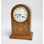 An Edwardian marquetry mantel clock with enamel dial, the case inlaid with swags, 26cm high