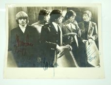 The Rolling Stones; a signed 1960s photograph including; Mick Jagger, Bill Wyman, Brian Jones, Keith