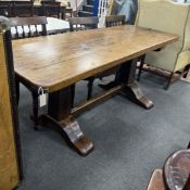 An 18th century style rectangular oak refectory table with single plank top on square end standards,