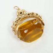 A 9ct and citrine coloured paste set swivelling fob, 30mm, gross weight 14.7 grams.