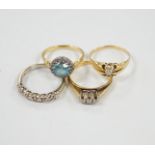 Three assorted 18ct and gem set dress rings, including blue zircon and diamond chip and claw set