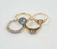 Three assorted 18ct and gem set dress rings, including blue zircon and diamond chip and claw set
