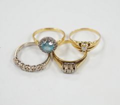 Three assorted 18ct and gem set dress rings, including blue zircon and diamond chip and claw set