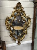 An 18th century style carved wood cartouche wall mirror, width 49cm, height 76cm