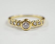 A 750 yellow metal and seven stone diamond set half hoop ring, size O, gross weight 3.6 grams.
