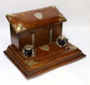A Victorian brass mounted oak desk stand with two silver mounted glass inkwells, 35cm wide
