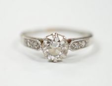 A white metal (stamped plat) and single stone diamond ring with diamond set shoulders, size M/N,