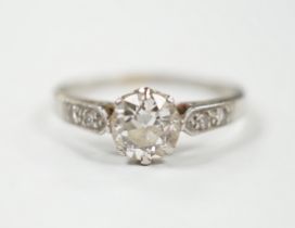 A white metal (stamped plat) and single stone diamond ring with diamond set shoulders, size M/N,