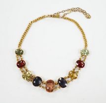 An early 20th century yellow metal and graduated multi-coloured oval cut zircon? set bracelet, 15.