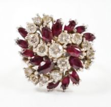 An 18ct, ruby and diamond set spiral cluster ring, size O, gross weight 7.7 grams.