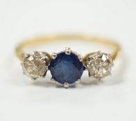 A yellow metal, single stone sapphire and two stone diamond set ring, size N/O, gross weight 2.2