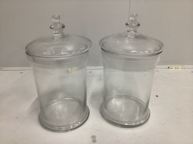 A pair of contemporary circular glass jars and covers, height 40cm
