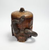 A Japanese carved wood tobacco jar in the form of a skull and snake, Meiji period, 21cm high