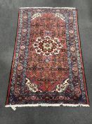 A Caucasian red ground rug, 206 x 130cm