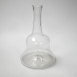 An early 18th century English lead crystal serving bottle, of long shaft and globe in the form of