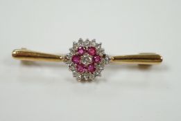 A 9ct, ruby and diamond cluster set bar brooch, 35mm, gross weight 2.7 grams.