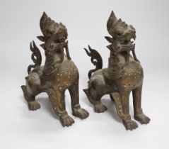 A pair of Thai bronze figures of lion dogs, 20cm