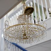A three tier brass and glass chandelier, 44cm diameter