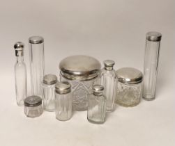 A group of assorted silver or white metal topped toilet jars, tallest 17.6cm.