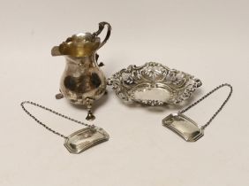 A late Victorian silver cream jug, Birmingham, 1894, 93mm, a repousse silver bonbon dish and a