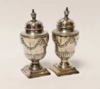 A pair of Victorian silver urn shaped pedestal pepperettes, Henry Wilkinson & Co Ltd, Sheffield,