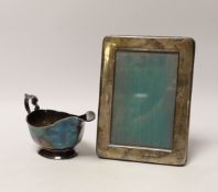 A modern silver sauceboat by Mappin & Webb and a modern silver mounted photograph frame.