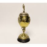A brass and plated goblet and cover raised on circular slate base, body signed A Cain, 25cm high