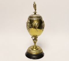 A brass and plated goblet and cover raised on circular slate base, body signed A Cain, 25cm high