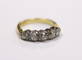 A modern 18ct gold and graduated five stone diamond set half hoop ring, size M, gross weight