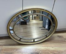 An oval marginal plate wall mirror, width 86cm, height 66cm