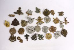 Thirty military cap badges including Royal Canadian Engineers, Royal Gloucestershire Hussars, the
