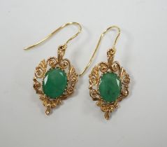 A pair of yellow metal and oval cut emerald set drop earrings, 23mm, gross weight 3.8 grams.
