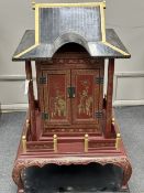 A Chinese scarlet and black lacquer temple shrine, height 112cm