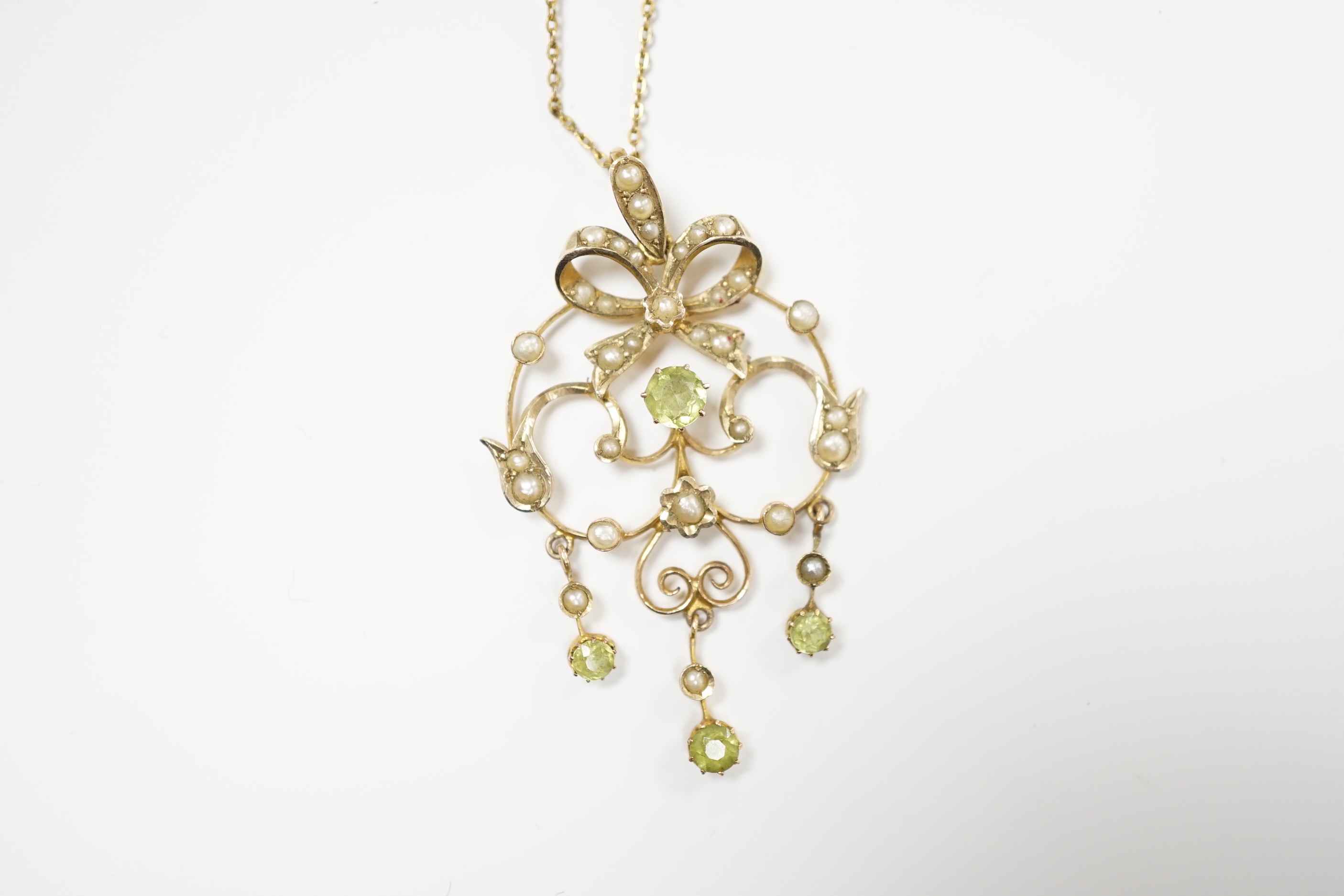 An Edwardian 9ct, peridot and seed pearl cluster set drop pendant, 47mm, on a gilt metal chan. - Image 2 of 3
