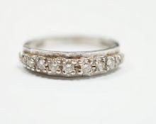 An 18ct white gold and diamond chip set half eternity ring, size M, gross weight 2.8 grams.
