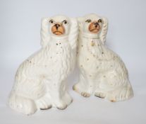 A pair of Staffordshire pottery dogs, 25cm high